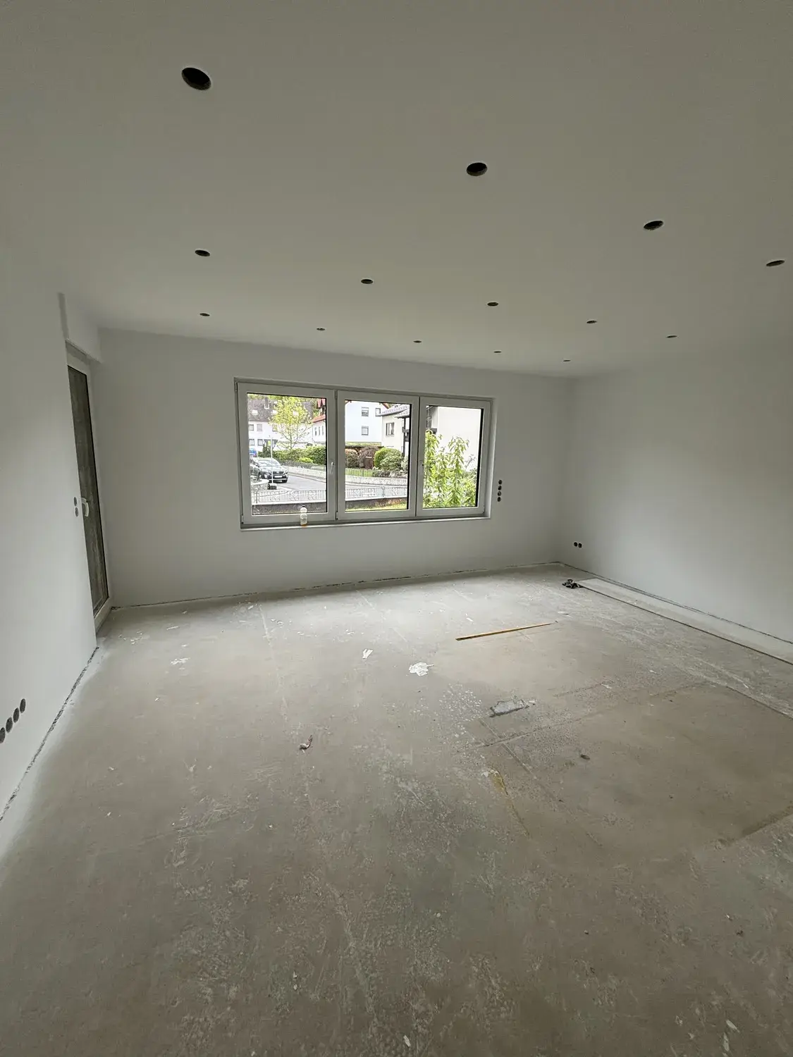 Dasselbe Zimmer mit neuer Spotdecke und weiß gestrichenen Wänden nach dem Innenausbau